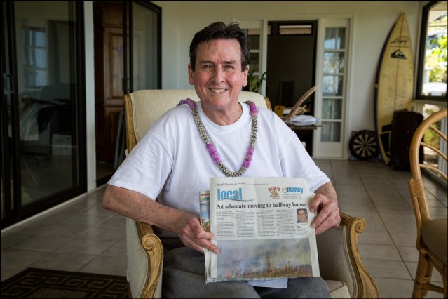 Cannabis advocate Roger Christie holds up Star-Advertiser story as he sits in candidate for governor Jeff Davis' home on the way to Mahoney Hale, a halfway house in downtown Honolulu. on September 11, 2014