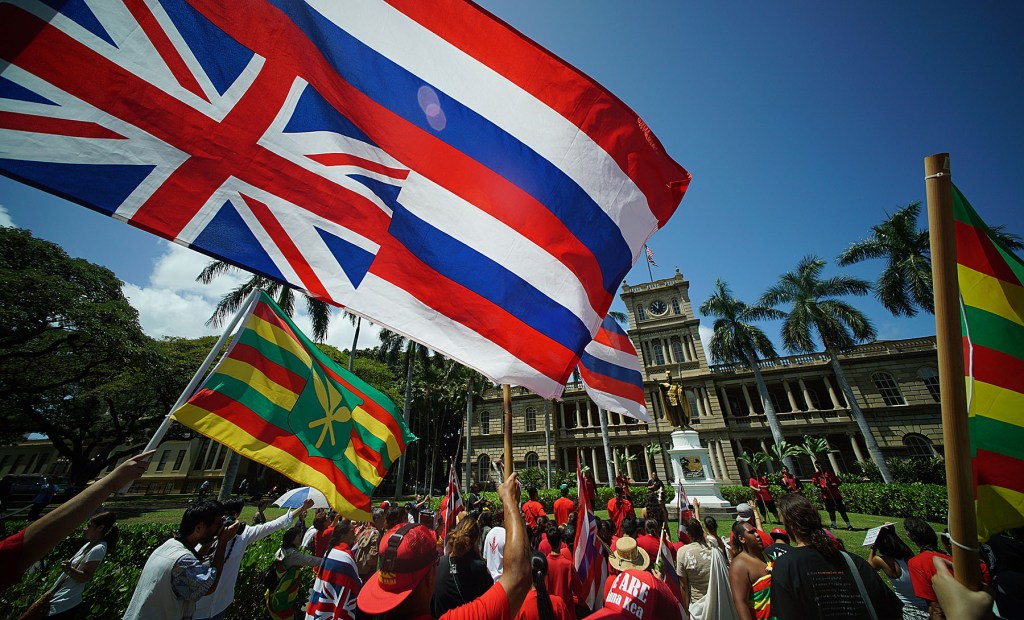 Demonstrators gather at he KIng Kamehameha statue on their way to the Governor’s office. 21 april 2015. photograph Cory Lum/Civil Beat