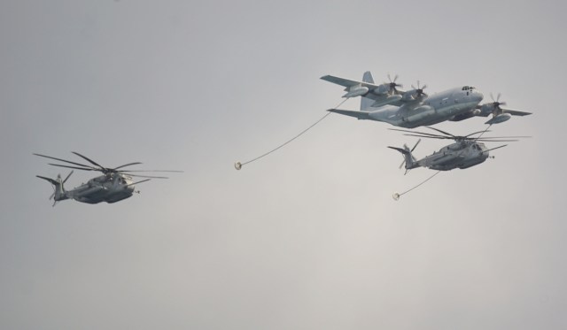 RIMPAC KC-130 Hercules flanked by CH-53E Helicopters. The KC-130 ca carry more than 12,000 gallons of fuel and simultaneously refuel two aircraft at 300 gallons of fuel per minute. 30 july 2016