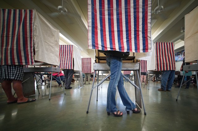 Fashionable heals bedecked voter as she casts her ballot at Kahaluu Elementary School. 8 nov 2016 9:54am.