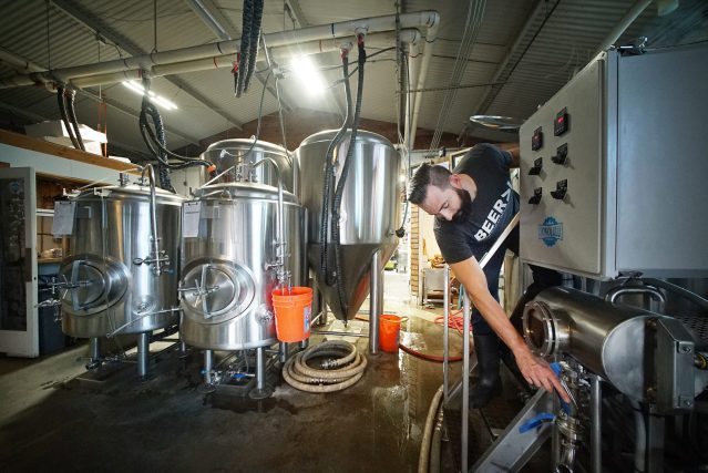 Brewer Ken Caldwell makes adjustments on a myriad of handles controlling various valveson the wort kettle during the processing of making wort before hops are applied. 10 may 2017
