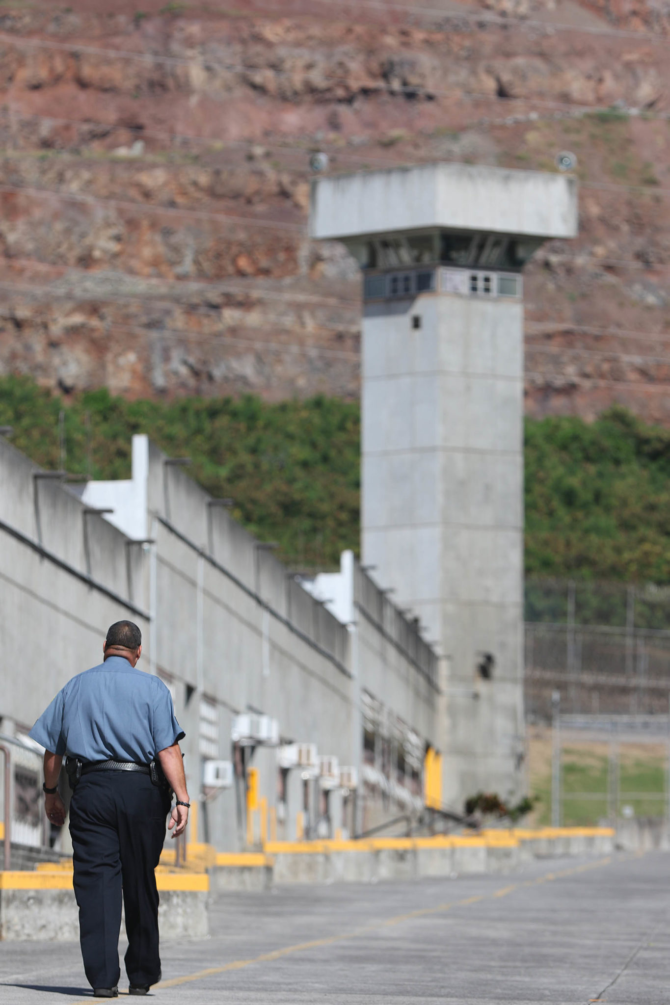 Halawa prison guard walks down 'Main Street' as inmates traverse from modules to modules. file photograph from 2015 December.