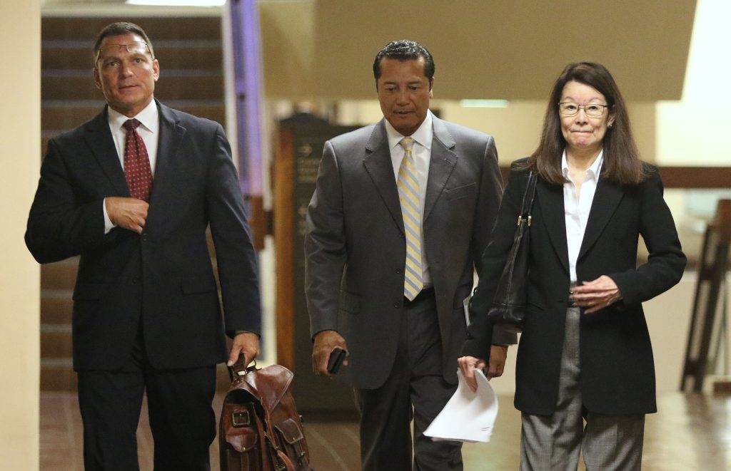 Deputy Prosecutor Duane Kokesch, center Attorney William Harrison and right, Deputy Atty Jan Futa walk to Judge Trader's court room for Grube's hearing.