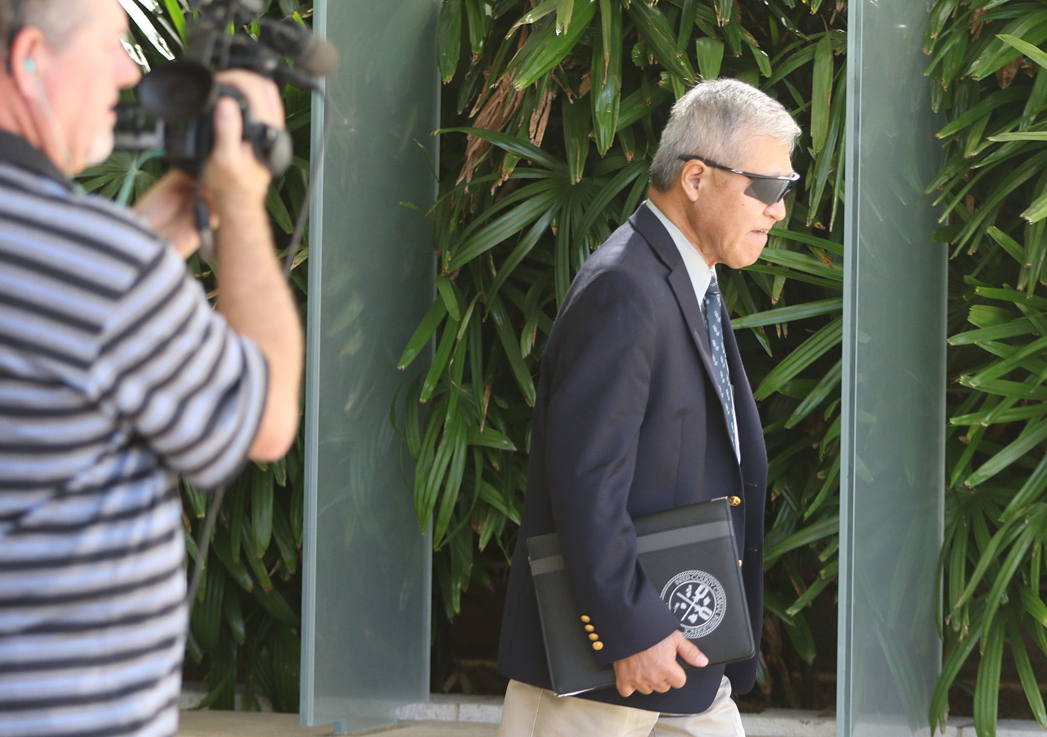 Prosecutor Keith Kaneshiro leaves District Court.
