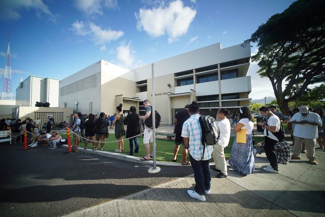 Scores of people line up before 8am at the Kapalama Driver License Office of Honolulu.