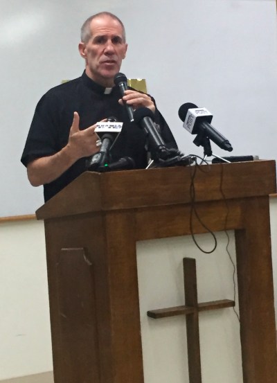 Archbishop Michael J. Byrnes announces that the Roman Catholic Church in Guam will file Chapter 11 reorganization bankruptcy in the coming weeks, Wednesday, Nov. 7, 2018, in Hagatna, Guam. The move will allow the archdiocese to avoid trial in dozens of lawsuits alleging child sexual abuse by priests and move toward settlements. (AP Photo/Grace Garces Bordallo)