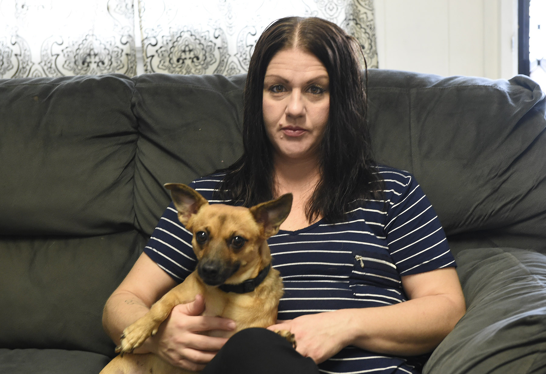 Amber Reynolds sits with her dog Irie in her Kaneohe home Friday, November 16, 2018. Reynolds says that her pet and companion helps her to deal with stress.