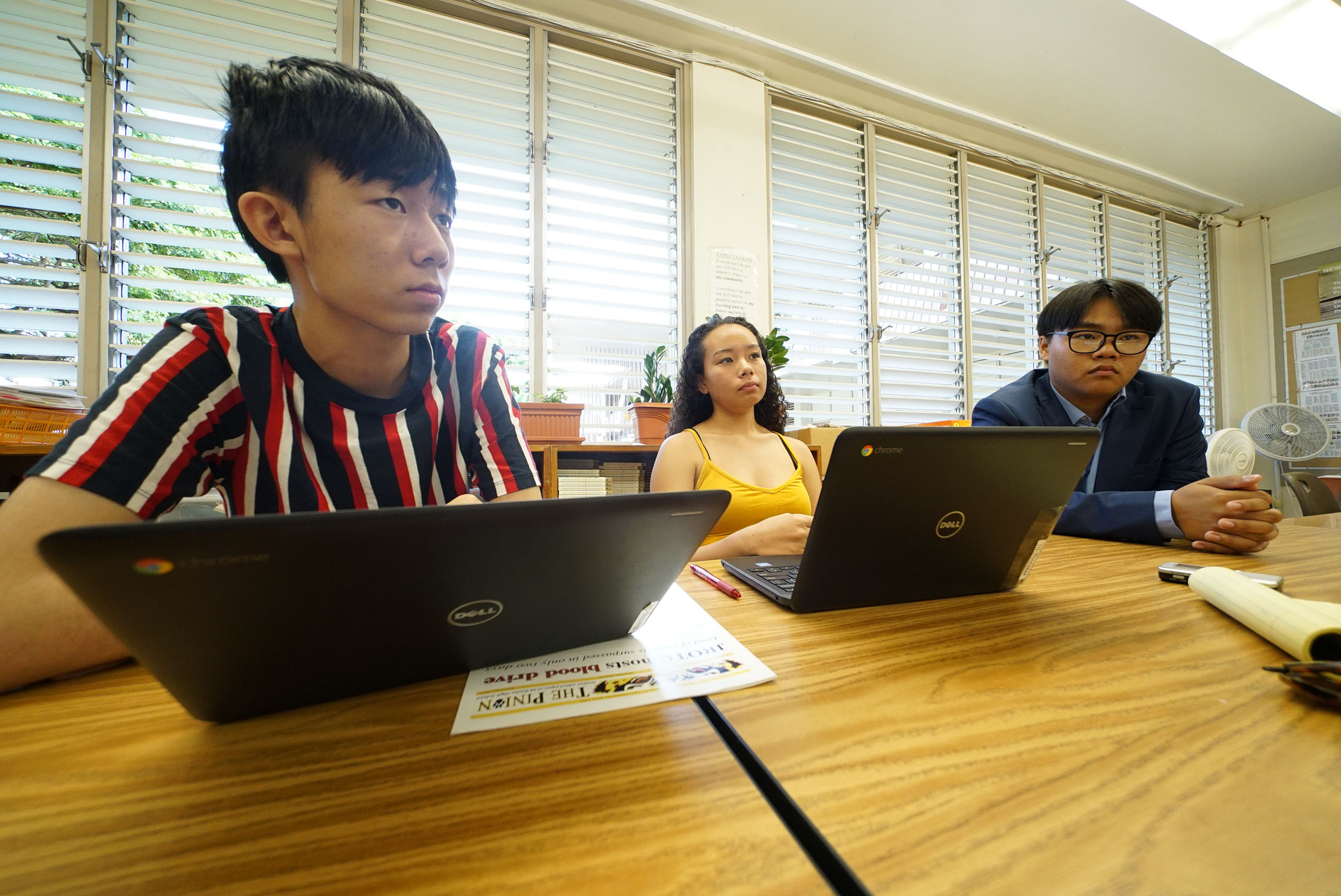 L-R, 16-yr-old Kelvin Ku, 16-yr-old Alexandria Buchanan and right, 17-yr-old Thompson Wong in Cindy Reves’ journalism class at McKinley High School.