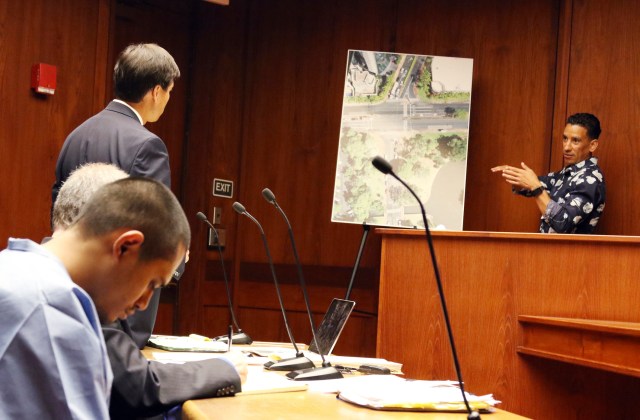 Prosecuting attorney Scott Bell, standing at left, listens to Cesar Garcia, right, testify about what he saw before and after a crash that killed three pedestrians during a preliminary hearing for Alins Sumang, foreground left, in Honolulu, Monday, Feb. 4, 2019. Sumang is charged with three counts of manslaughter and police say he was drunk and speeding when he slammed into a crowded pedestrian island. (AP Photo/Jennifer Sinco Kelleher)