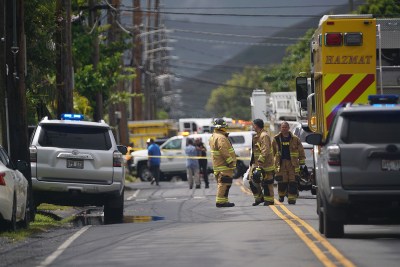 Honolulu Fire Dept personnel along Oneawa Street in Kailua after helicopter crashed in a residential neighborhood.