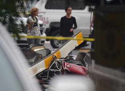 Parts of the helicopter rests along Oneawa Street in Kailua after helicopter crashed in a the Kailua neighborhood.