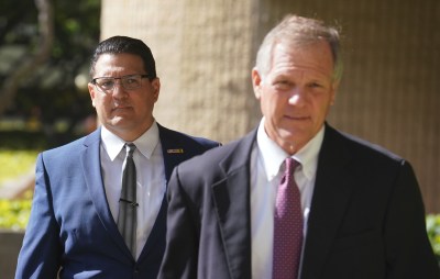 Attorney Birney Bervar arrives with Derek Hahn at District Court for first day of trial.