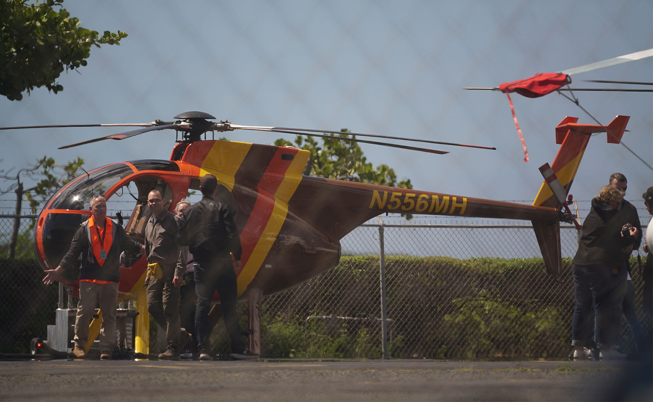 Customers return from a doors off tour on Magnum Helicopters tour.