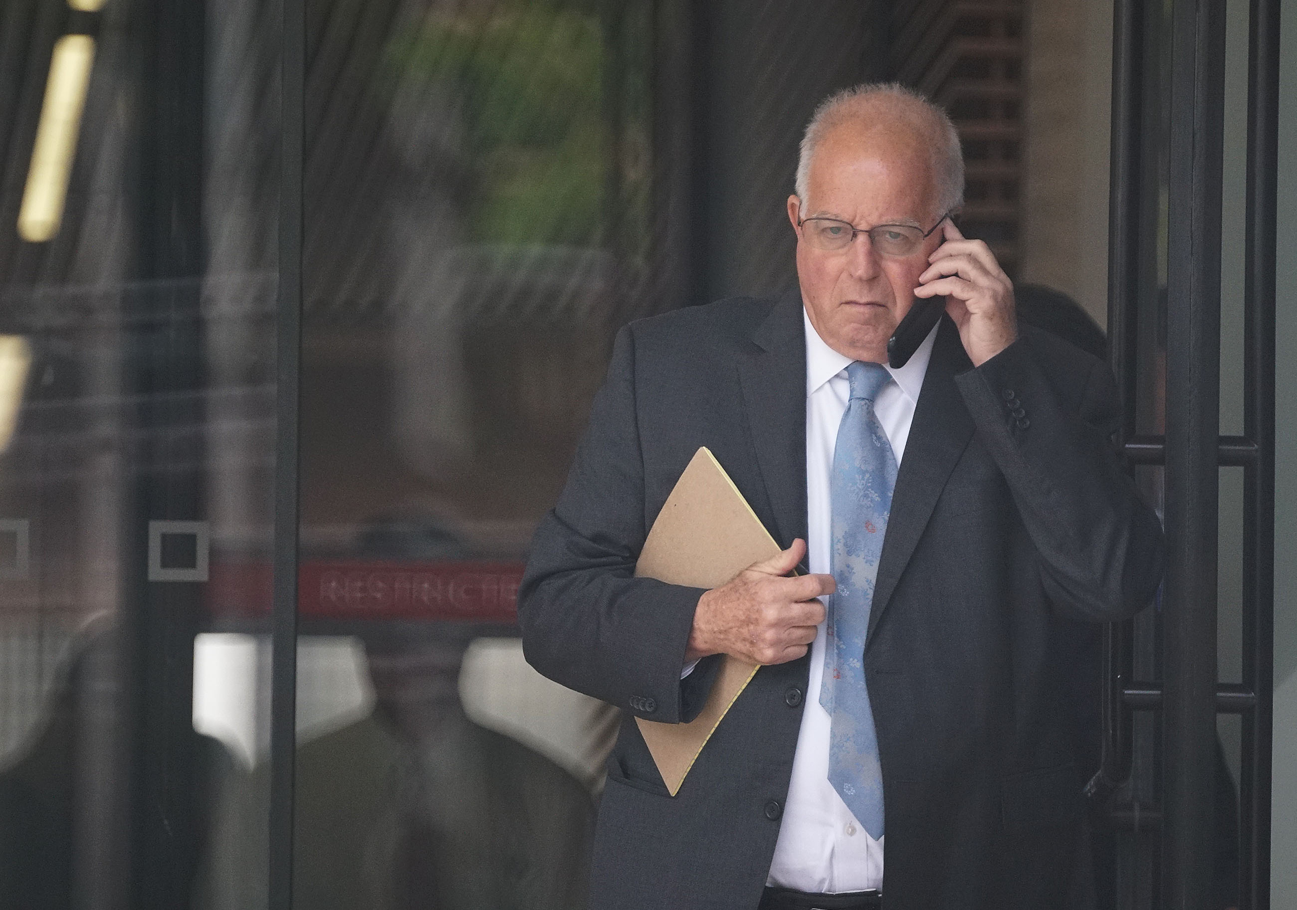Attorney Eric Seitz leaves District Court on lunch recess.