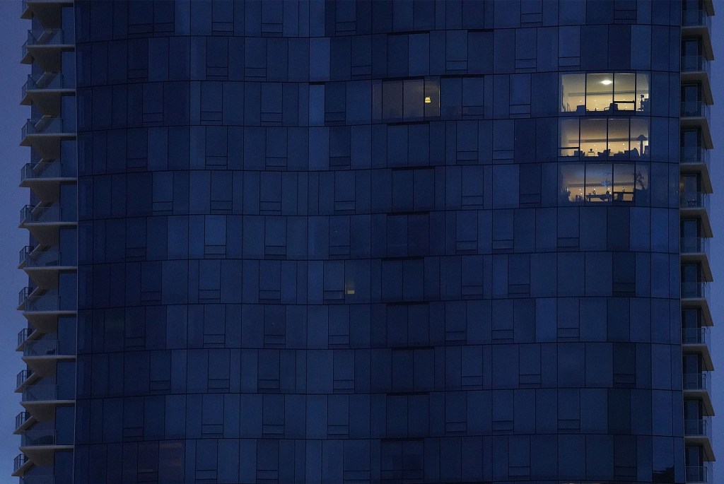 Waiea Condominium in Kakaako with very few lights on.
