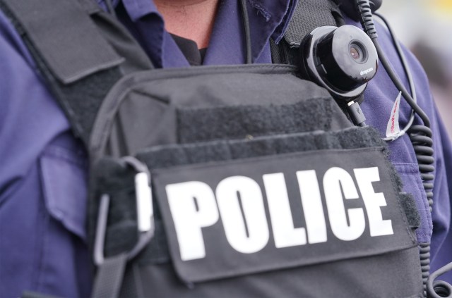 HPD Officer at Mauna Kea Access Road with camera. July 17, 2019