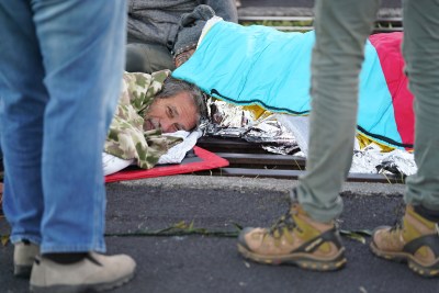 TMT Demonstrator Walter Ritte lays face down chained to the cattle grate. July 15, 2019