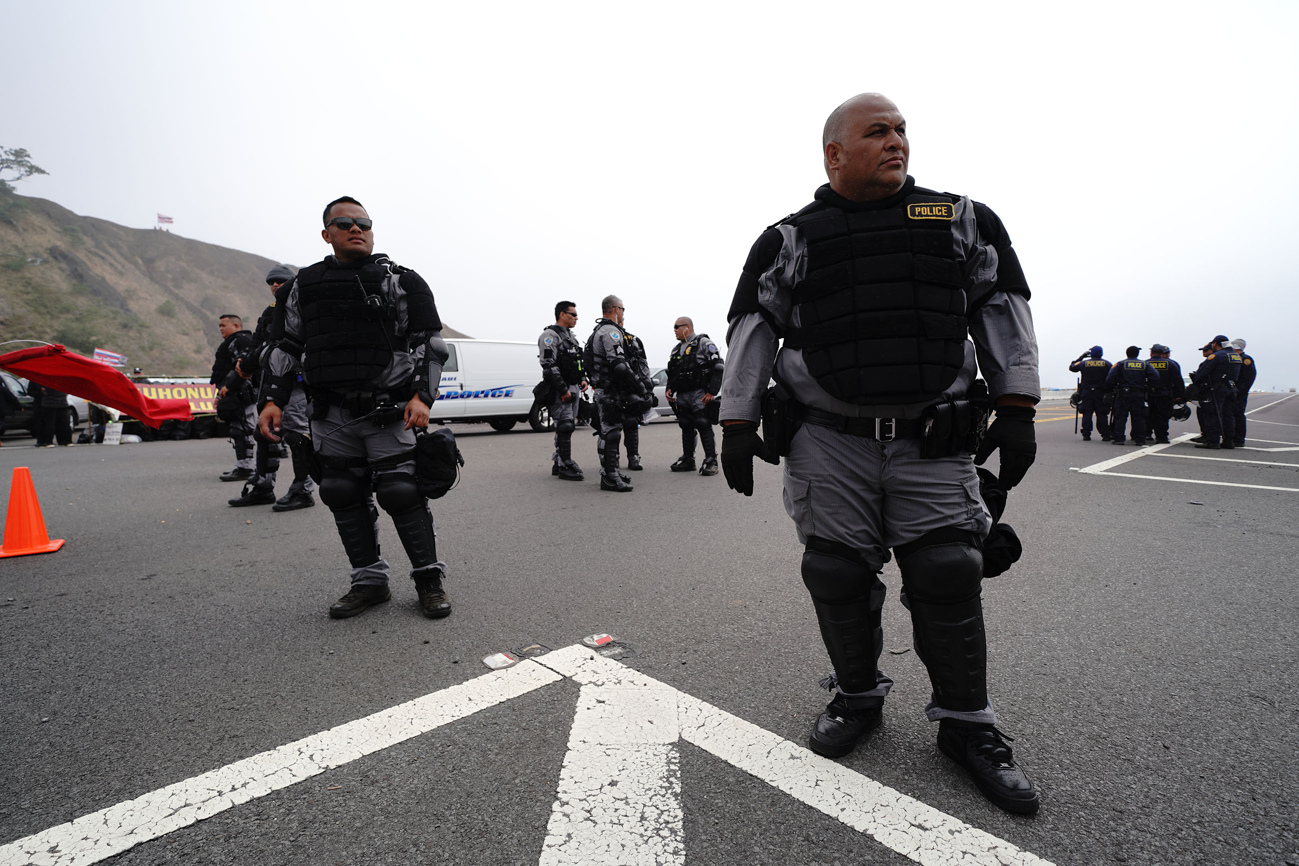 TMT Saddle Road Mauna Kea Access Road, Maui Police Dept in riot gear wait for the next shift replacing officers along the access road. July 17. 2019