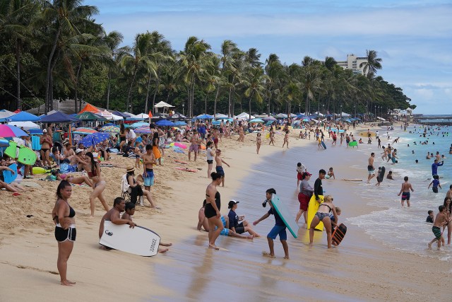 Crowds on 4th of July at Waikiki Beach near the Kapahulu groin .