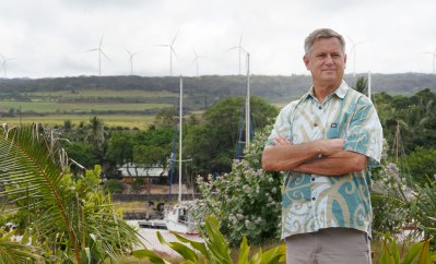 Senator Gil Riviere stands at Alii Park in Haleiwa with windmills above Waimea Bay.