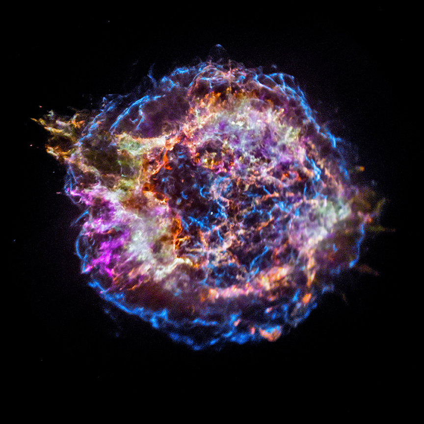 This image from NASA’s Chandra X-ray Observatory shows the location of different elements in the Cassiopeia A supernova remnant including silicon (red), sulfur (yellow), calcium (green) and iron (purple). Each of these elements produces X-rays within narrow energy ranges, allowing maps of their location to be created. The blast wave from the explosion is seen as the blue outer ring. Astronomers study supernova remnants to better understand how stars produce and then disseminate many of the elements on Earth and in the cosmos at large.