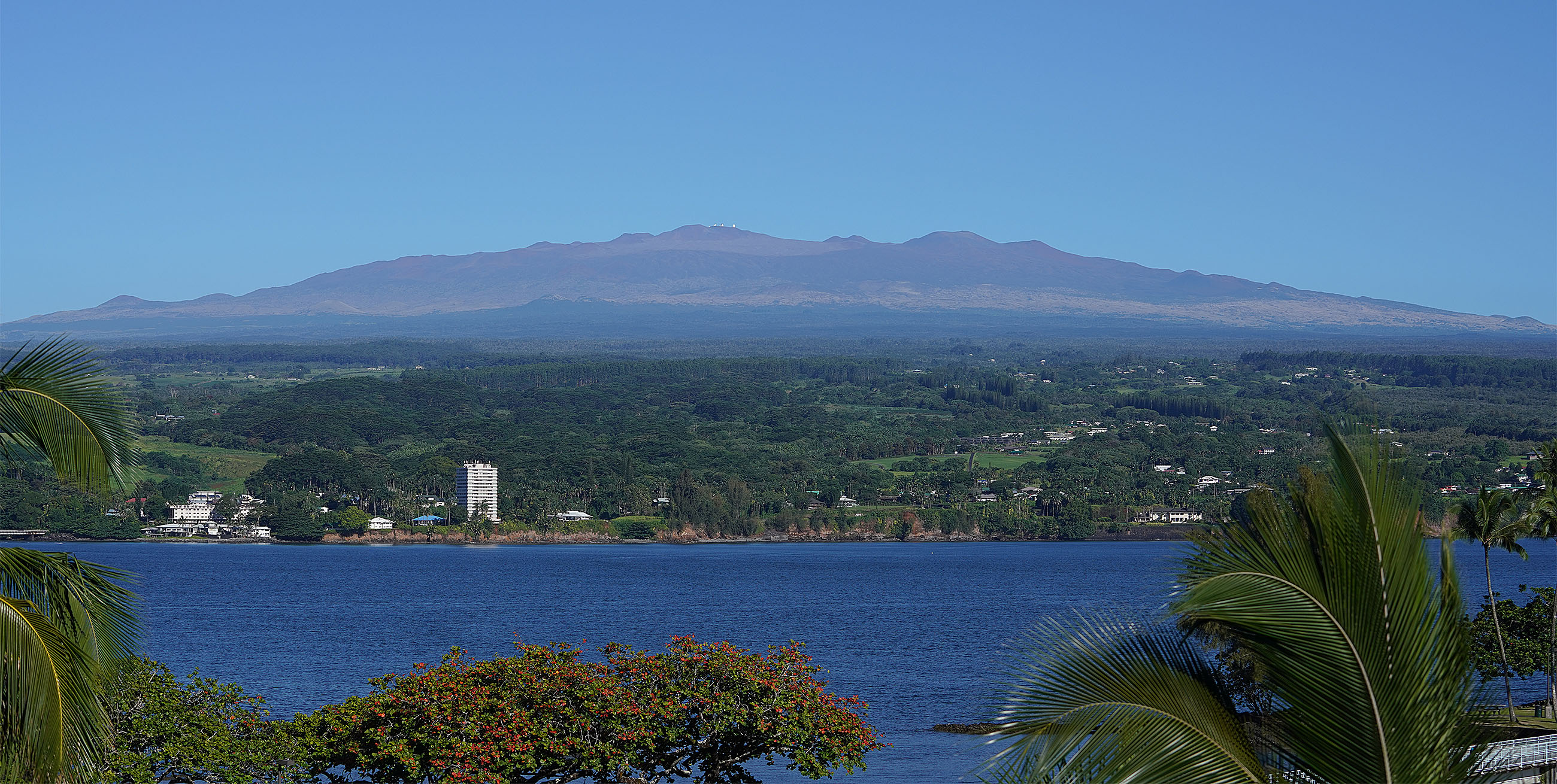 Hilo Bay with the majestic view of Mauna Kea with tiny dots on the summit, the observatories.