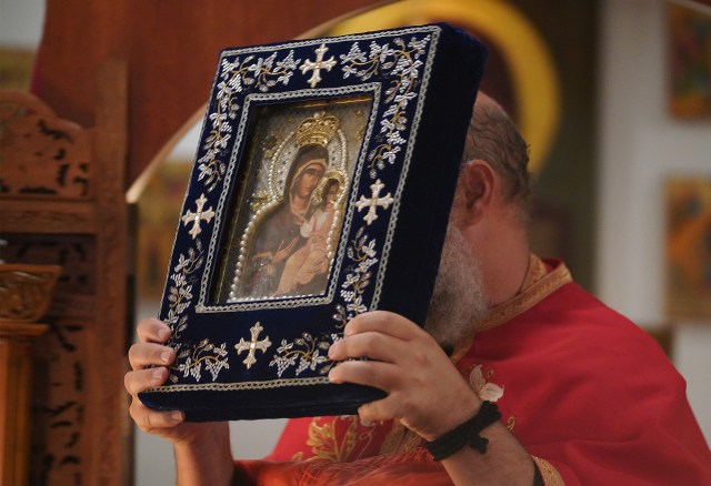 Holy Theotokos of Iveron Russian Orthodox Church Father Athanasius Kone holds the icon during worship services.