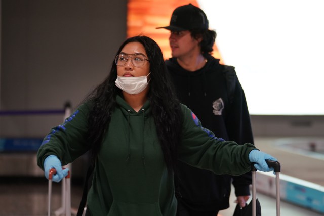 Left, Kayla Damo and kai Ruperti arrive at Daniel K. Inouye International Airport during a 14-day quarantine for out of state visitors due to Coronavirus concerns.