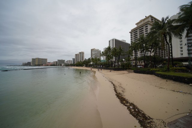 Very people were enjoying the beach on a rainy day in Waikiki.
