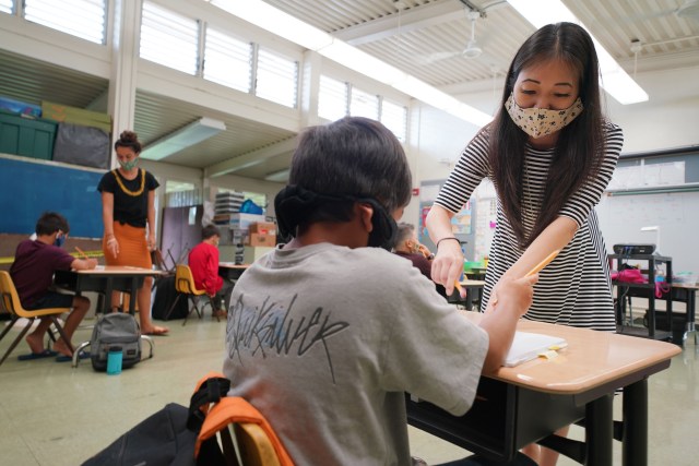 Kaneohe Elementary School summer school teacher Jacque Yoshizumia helps a student during COVID-19 pandemic. June 12, 2020