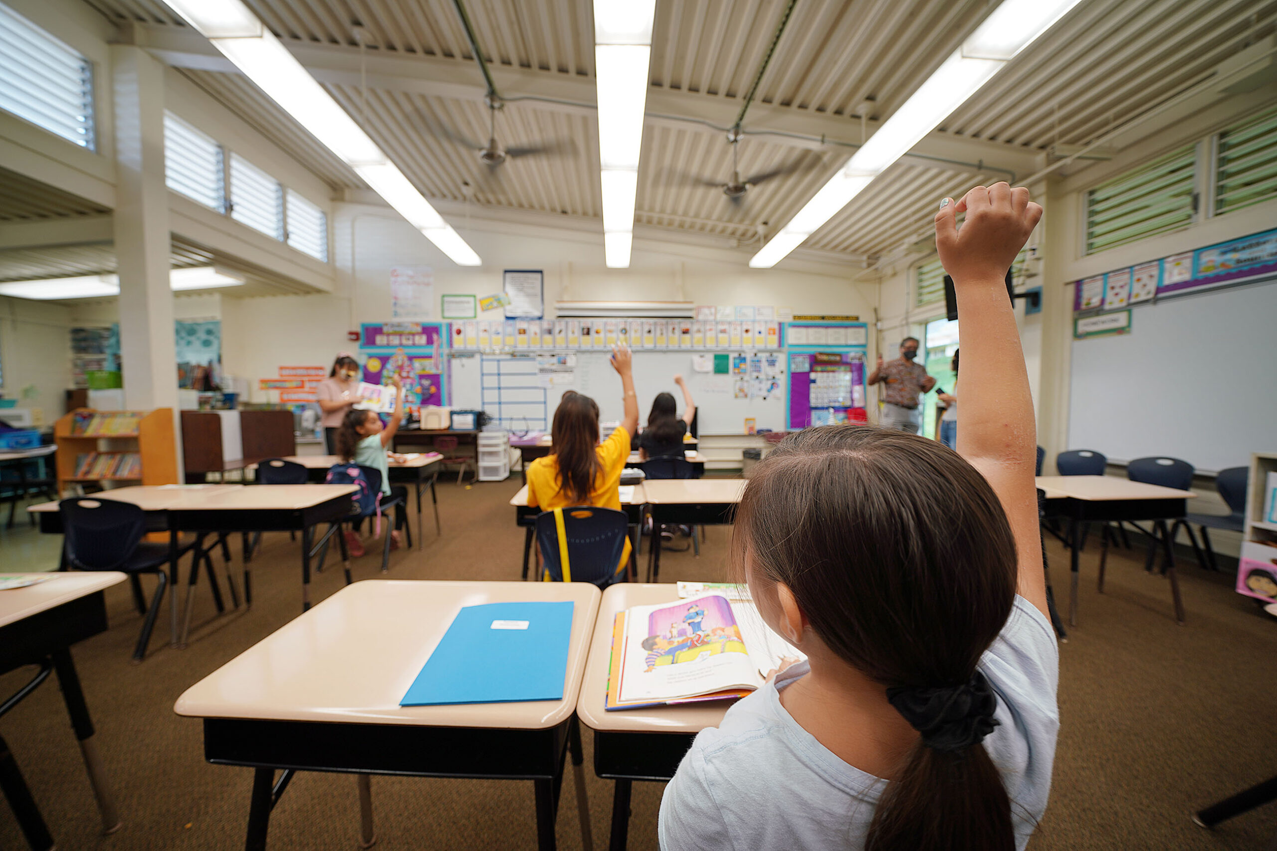 Kaneohe Elementary School summer school student raises her hand in class during COVID-19 pandemic. June 12, 2020