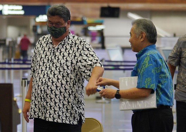 Senate President Ron Kouchi gives Governor David Ige knuckles after a press conference announcing that travelers that have a negative COVID-19 pre-test, would not be subjected to the quarantine. June 24, 2020