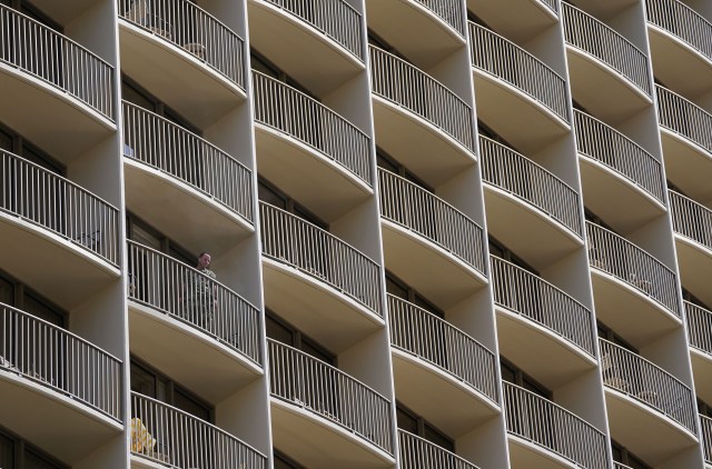 A visitor stands on the balcony of the Embassy Suites in Waikiki during COVID-19 pandemic. July 23, 2020