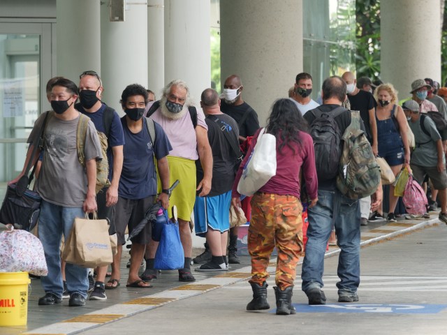 As shelters across Oahu opened up Sunday morning people began lining up outside the Hawaii Convention Center in Honolulu, HI seeking a safe place to weather Hurricane Douglas on July 26, 2020. Forecasters warn of damaging wind, heavy rainfall, and dangerously high surf in anticipation for the category 1 hurricane. (Ronen Zilberman photo Civil Beat)