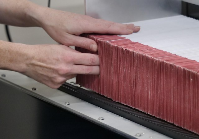 Amanda Brockway from the office of the City Clerk Elections Division City & County of Honolulu feeds envelopes into a ballot sorting machine on Friday, August 7, 2020. (Ronen Zilberman photo Civil Beat)