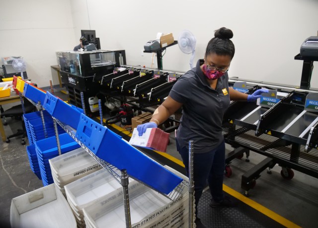 Zakiya Potts from the office of the City Clerk Elections Division City & County of Honolulu packs ballot envelopes into bins, after verification and validation checks, on Friday, August 7, 2020. The ballots will be sent to the election board for counting. (Ronen Zilberman photo Civil Beat)