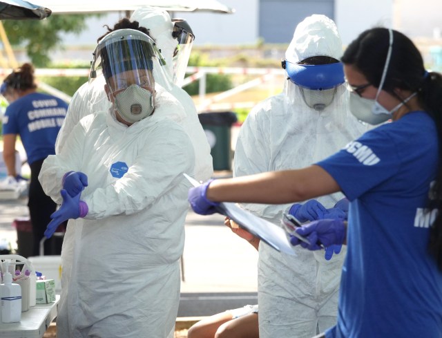 Members of the COVID Command Mobile Unit prepare to collect samples from Oahu residents during a drive-thru event held in Kaka'ako Sunday, August 16, 2020. (Ronen Zilberman photo Civil Beat)