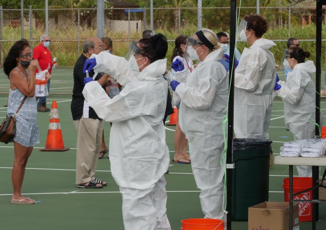 Medical technicians show people how to administer self-tests for COVID-19 during a free testing event at the Waimanalo District Park, Friday, August 28, 2020. (Ronen Zilberman photo Civil Beat)