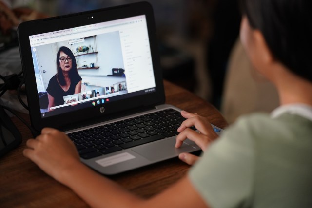 Distance learning as students return to school via teleconferencing daily class lessons with their teachers during COVID-19 pandemic.