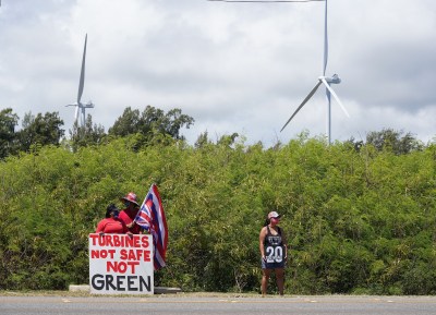 Opponents of the Kahuku windmills socially distance along Kamehameha Highway.