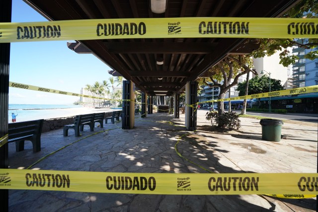 Parks Closed along Waikiki Beach, covered benches along Kalakaua Avenue have yellow tape during COVID19 surge in Honolulu. August 12, 2020