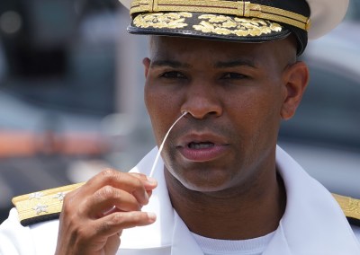 Vice Admiral Jerome Adams US Surgeon General demos swab test in nostril by rotating the swab five times around the entrance of the nostril during COVID-19 surge testing conducted at Leeward Community College. August 26, 2020