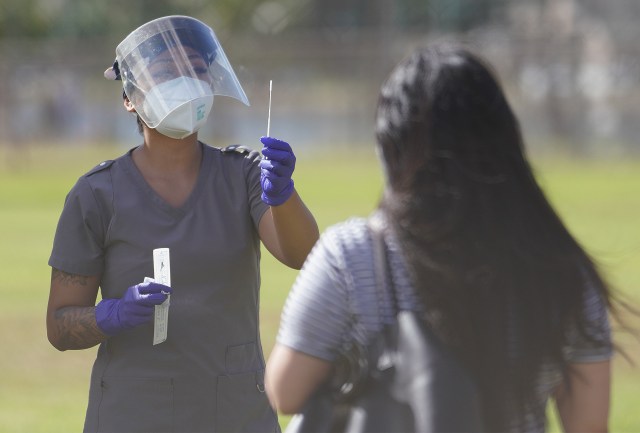 Medical personnel assist by giving directions on how to self swab during COVID-19 surge testing held at Ala Wai Park on the baseball field. September 5, 2020