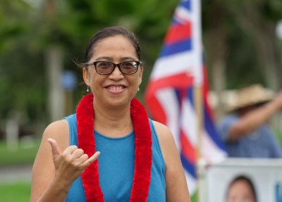 Honolulu City Council District 3 candidate, Esther Kia'aina flashes a shaka while sign waving on the Windward side of Oahu, Tuesday, October 27, 2020. (Ronen Zilberman photo Civil Beat)