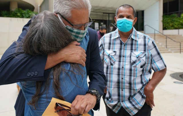 Louis Kealoha is hugged by a supporter outside US District Court.