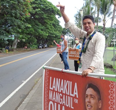Lanakila Mangauil, candidate for Big Island OHA Trustee , sign-waves with supporters in Naalehu. Photo: Tim Wright