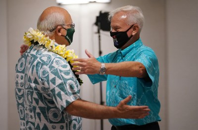 Mayor Kirk Caldwell gives a lei to Mayoral candidate Rick Blangiardi at the Alohilani Hotel.