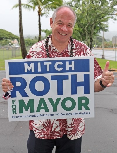 Mitch Roth candidate for Big Island Mayor holds up his sign outside of his Hilo campaign office. Photo: Tim Wright