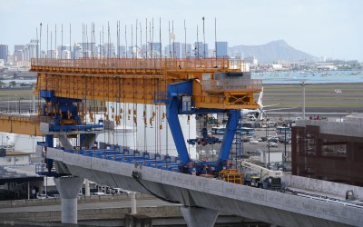 Rail guideway continues to downtown Honolulu near Daniel K. Inouye International Airport with a view of Diamond Head on the right.