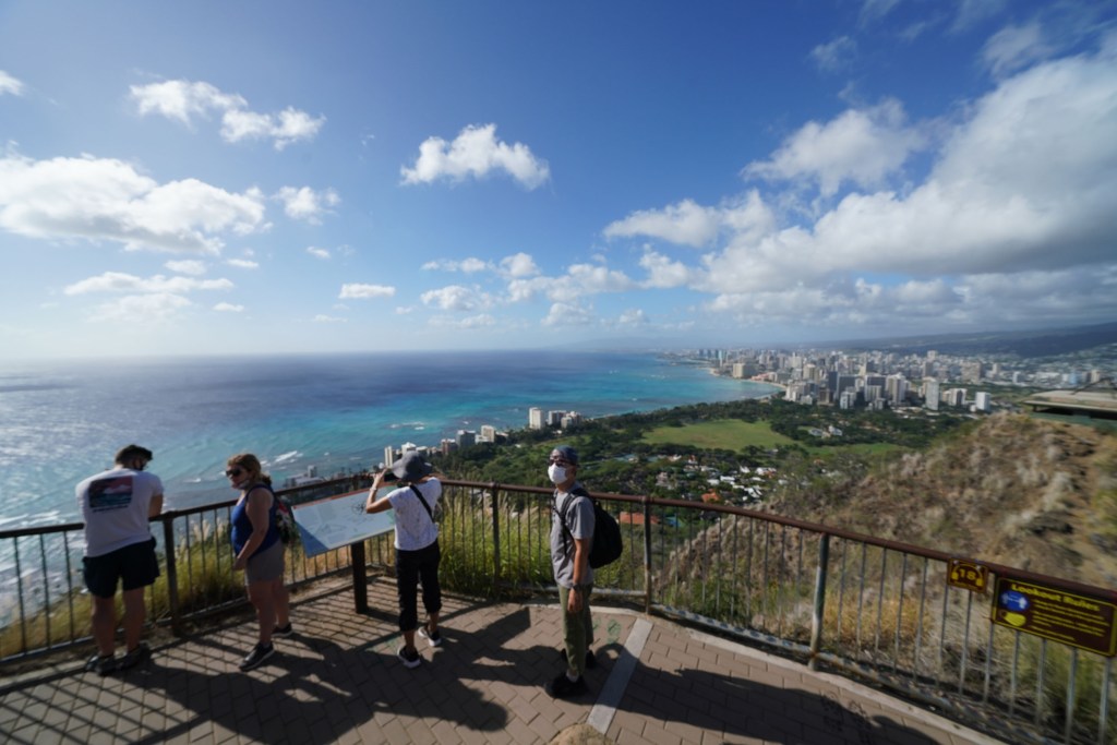 Hikers enjoy the Diamond Head summit socially distanced during the COVID-19 pandemic.